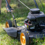 person mowing the lawn at the end of summer