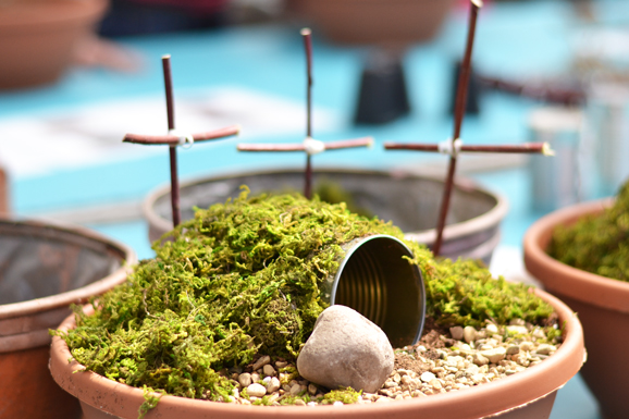 resurrection garden with tomb and three crosses in planter